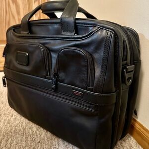 Tumi Black Travel Bag with Structured Design and Expandable Sections